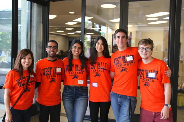 Student group in orange West ʮϲ shirts